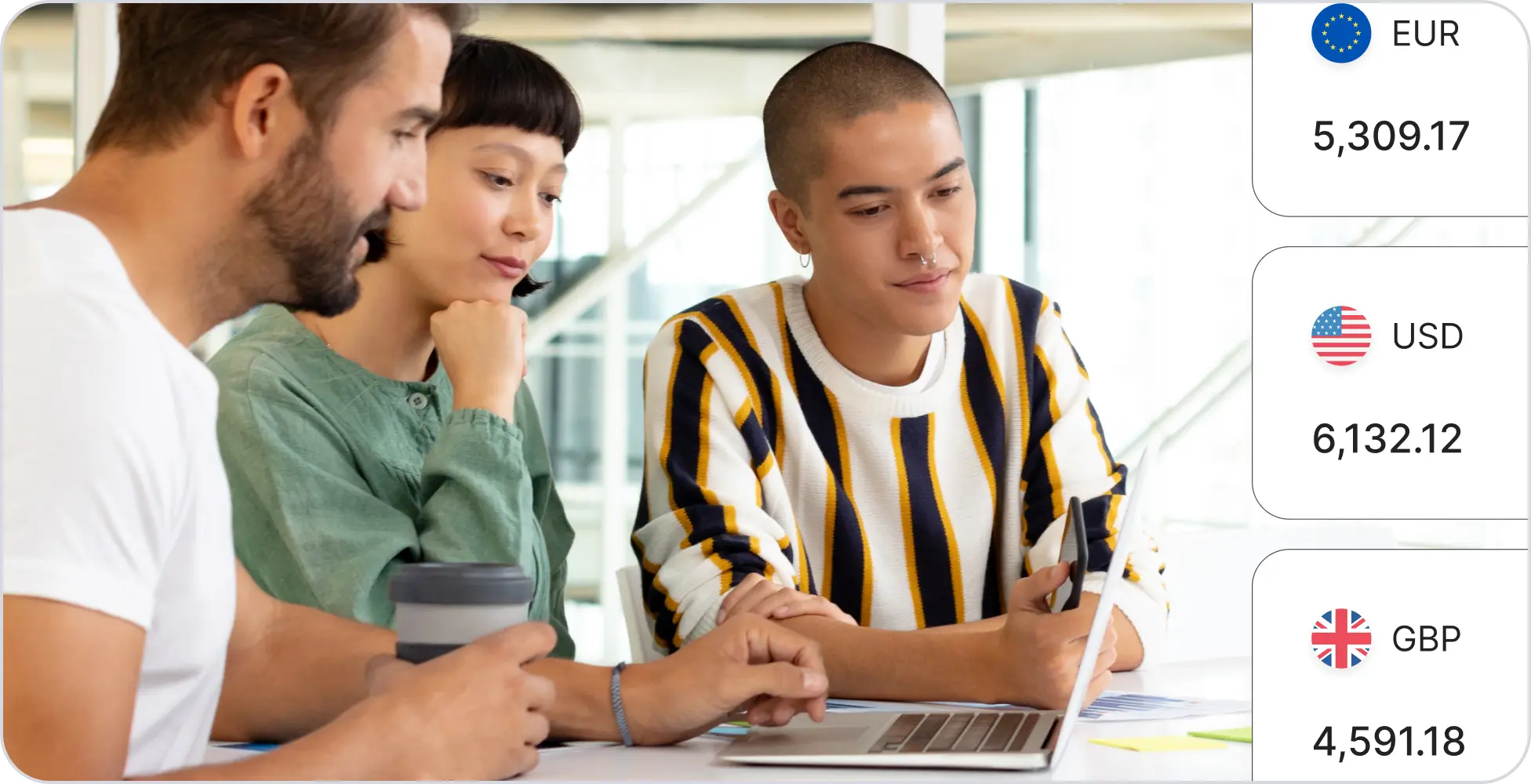 A team collaborating around a laptop with local currency balances